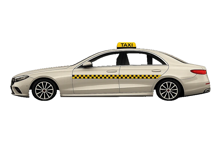 Beiges Taxi mit gelbem Taxischild fährt von rechts ins Bild